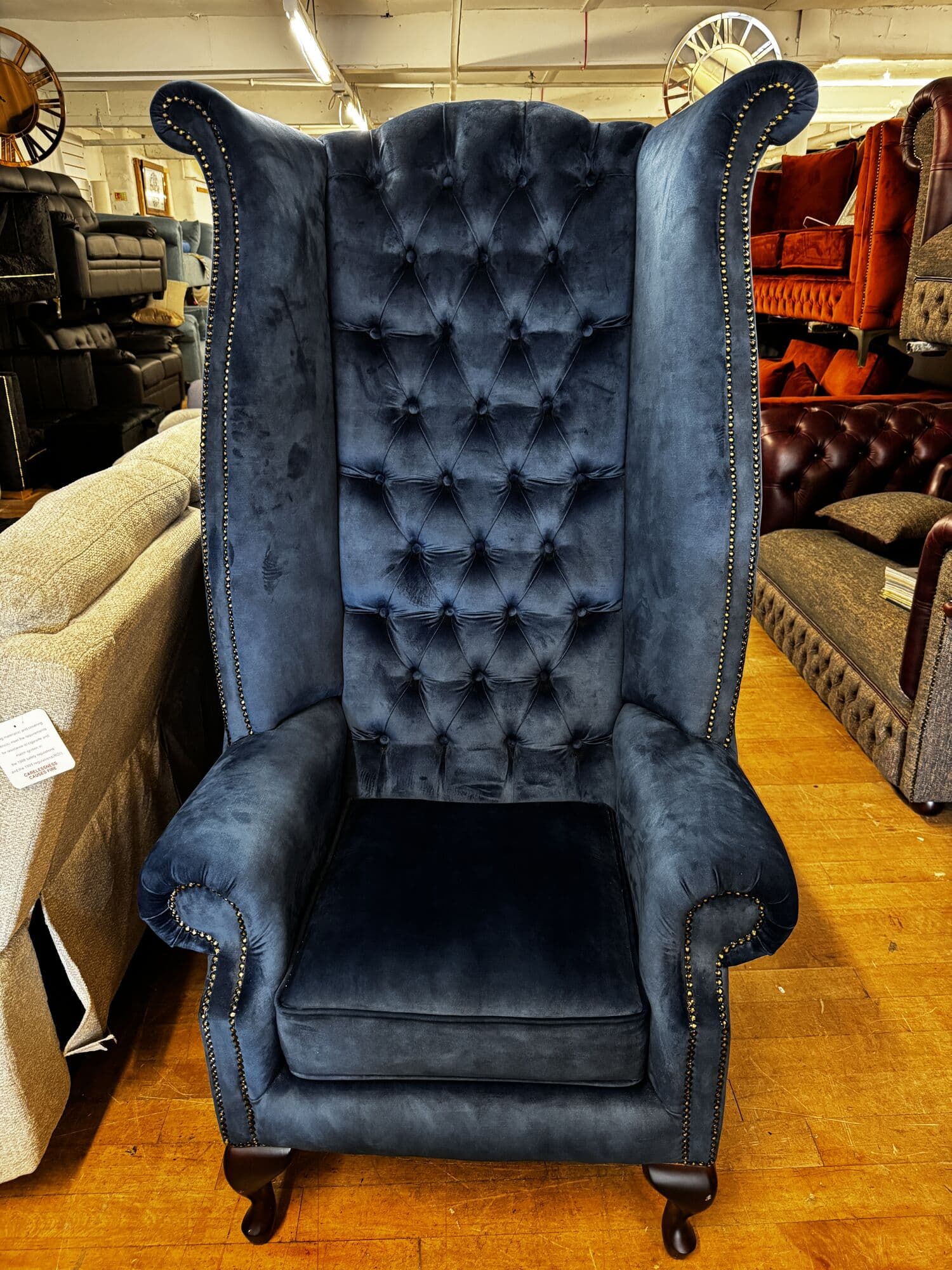 Navy velvet high wingback chair with deep buttoning
